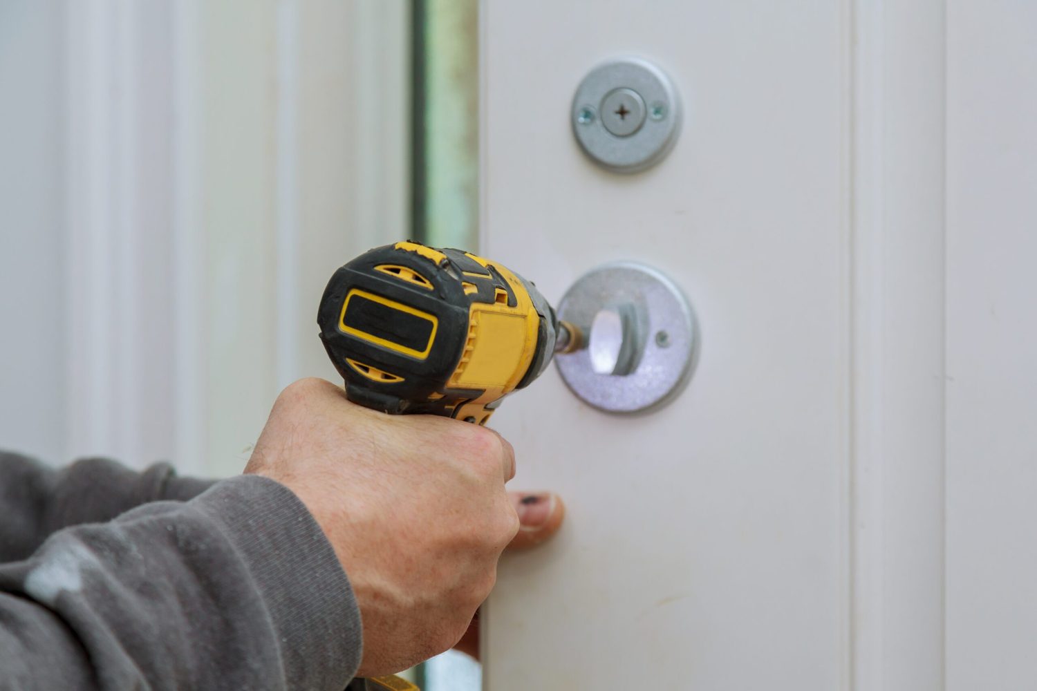 Carpenter installation at interior wood door lock of an apartment